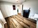 Bedroom features closet, wood floors, and black dresser with decor and lamp at 9089 Dupont Ave, Spring Hill, FL 34608