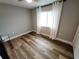 Bright bedroom features wood floors, neutral paint and a window with curtains at 9089 Dupont Ave, Spring Hill, FL 34608