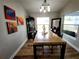 Dining room featuring modern table with light-colored floors and lots of natural light streaming through the windows at 9089 Dupont Ave, Spring Hill, FL 34608
