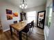 Cozy dining room with modern art, decorations, and a large mirror reflecting the light at 9089 Dupont Ave, Spring Hill, FL 34608