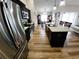 Modern kitchen with black cabinets, stainless steel appliances, and a kitchen island at 9089 Dupont Ave, Spring Hill, FL 34608
