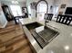 Stainless steel farmhouse sink and fixture inside a light and airy open-concept kitchen space at 9089 Dupont Ave, Spring Hill, FL 34608