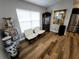 Sitting area with wood floors, two white chairs, and a decorative mirror and vases at 9089 Dupont Ave, Spring Hill, FL 34608