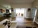 Living room with wood floors showing dining area and outdoor patio through sliding glass doors at 9089 Dupont Ave, Spring Hill, FL 34608