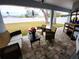 Covered patio has brick pavers, lounge furniture and view of backyard at 9089 Dupont Ave, Spring Hill, FL 34608