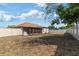 Spacious backyard featuring a screened porch and well-maintained fence, offering privacy and outdoor enjoyment at 9100 Whitman Ln, Port Richey, FL 34668