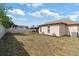 Expansive backyard featuring ample space, privacy fence, and partial lawn, ideal for outdoor activities and relaxation at 9100 Whitman Ln, Port Richey, FL 34668