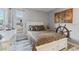Comfortable bedroom with stylish nautical decor, bright window, and wood-look flooring at 9100 Whitman Ln, Port Richey, FL 34668