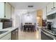 Open-concept kitchen and dining area, ideal for entertaining with easy access to the living room at 9100 Whitman Ln, Port Richey, FL 34668