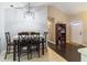 Cozy dining room features modern lighting, neutral paint, and dark wood furniture at 9100 Whitman Ln, Port Richey, FL 34668