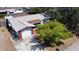 A charming home with a brick accent, single car garage and driveway surrounded by green trees and lush landscaping at 9104 Lido Ln, Port Richey, FL 34668