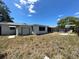 A spacious backyard with a white shed, stone patio and plenty of room for outdoor activities at 9104 Lido Ln, Port Richey, FL 34668