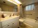 Bathroom featuring a vanity sink, bathtub with shower, and tiled walls at 9104 Lido Ln, Port Richey, FL 34668