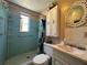 Cozy bathroom featuring a tiled shower, and sink with a small countertop at 9104 Lido Ln, Port Richey, FL 34668