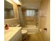 Traditional bathroom featuring a tub and shower combo with neutral tile and a single sink vanity at 9104 Lido Ln, Port Richey, FL 34668