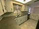 Kitchen with updated counters and fixtures and abundant natural light at 9104 Lido Ln, Port Richey, FL 34668