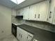 Kitchen featuring white cabinets and a black stove and oven at 9104 Lido Ln, Port Richey, FL 34668