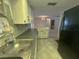 Clean kitchen featuring white cabinets, modern counters, and updated appliances at 9104 Lido Ln, Port Richey, FL 34668