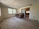 Spacious living room with natural light, built-in shelving, and carpeted flooring at 9104 Lido Ln, Port Richey, FL 34668