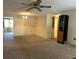 Spacious living room with soft carpet and a charming chandelier creates a warm and inviting atmosphere at 9104 Lido Ln, Port Richey, FL 34668