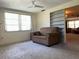 Cozy living room with large windows, carpet, and built-in bookshelves at 9104 Lido Ln, Port Richey, FL 34668