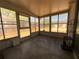 Enclosed sunroom with large windows offering natural light and a view of the backyard at 9104 Lido Ln, Port Richey, FL 34668