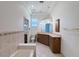 Bright bathroom featuring double sinks, lots of cabinet space, granite counters, and tiled floors at 9237 Penelope Dr, Weeki Wachee, FL 34613