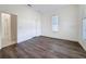 Bright bedroom with hard wood floors, two windows, and a bathroom view at 9237 Penelope Dr, Weeki Wachee, FL 34613