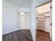 An open bedroom boasts wood floors and an open walk-in closet with custom shelving at 9237 Penelope Dr, Weeki Wachee, FL 34613