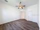 Bedroom with ceiling fan and wood-look flooring at 9237 Penelope Dr, Weeki Wachee, FL 34613