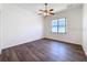 Bright bedroom with modern ceiling fan and wood-look flooring at 9237 Penelope Dr, Weeki Wachee, FL 34613