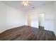 Bright bedroom with modern ceiling fan and wood-look flooring at 9237 Penelope Dr, Weeki Wachee, FL 34613
