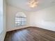 Bright bedroom with hard wood floors, a ceiling fan, and two windows at 9237 Penelope Dr, Weeki Wachee, FL 34613