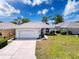 Inviting single-story home with a two-car garage, landscaped front yard, and a freshly paved driveway at 9237 Penelope Dr, Weeki Wachee, FL 34613