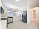 The remodeled kitchen offers white cabinets, stainless appliances, and an open layout ideal for entertaining guests at 9237 Penelope Dr, Weeki Wachee, FL 34613
