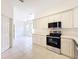 Bright kitchen with white cabinets and stainless steel appliances provides ample space and storage for cooking at 9237 Penelope Dr, Weeki Wachee, FL 34613