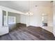 Bright, open living room featuring hardwood floors and decorative columns at 9237 Penelope Dr, Weeki Wachee, FL 34613