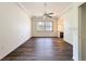 Open-concept living area featuring hardwood floors, a ceiling fan, and plenty of natural light at 9237 Penelope Dr, Weeki Wachee, FL 34613