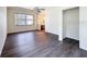 Open-concept living area featuring hardwood floors, a ceiling fan, and plenty of natural light at 9237 Penelope Dr, Weeki Wachee, FL 34613