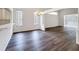 Open-concept living space featuring hardwood floors, natural light, and elegant chandelier at 9237 Penelope Dr, Weeki Wachee, FL 34613