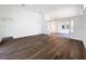 Spacious living room with hardwood flooring, white walls, and an open floor plan at 9237 Penelope Dr, Weeki Wachee, FL 34613