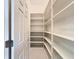 Pantry with multiple shelves and tiled floors at 9237 Penelope Dr, Weeki Wachee, FL 34613