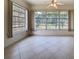 Bright sunroom with tile floors and windows overlooking the yard at 9237 Penelope Dr, Weeki Wachee, FL 34613