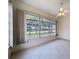 Bright sunroom features tile flooring, a ceiling fan, and large windows offering natural light and views at 9237 Penelope Dr, Weeki Wachee, FL 34613