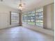 Bright sunroom features tile flooring, a ceiling fan, and large windows offering natural light and views at 9237 Penelope Dr, Weeki Wachee, FL 34613