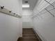 The walk-in closet features wood floors, white walls, shelving, and black hooks at 9237 Penelope Dr, Weeki Wachee, FL 34613