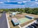 Aerial view of the community's shuffleboard courts, swimming pool, and adjacent parking at 9336 Santa Monica Way, New Port Richey, FL 34655
