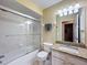 Well-lit bathroom with a shower/tub combination and granite vanity at 9336 Santa Monica Way, New Port Richey, FL 34655