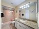 Bathroom featuring tile shower with glass door and granite countertop at 9336 Santa Monica Way, New Port Richey, FL 34655