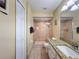 Bathroom view showcasing tile shower with glass door and granite countertop at 9336 Santa Monica Way, New Port Richey, FL 34655